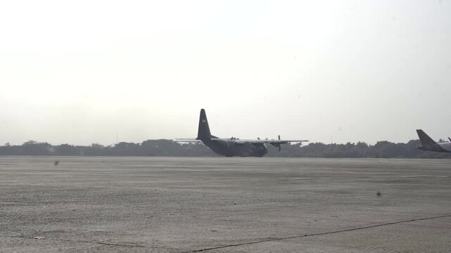 A Hercules aircraft is preparing for takeoff at an airport
