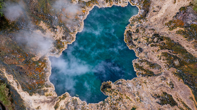 Aerial view of the steaming Sempaya Hot Springs in Semuliki National Park with vibrant mineral deposits and turquoise water in Bundibugyo, Western Region, Uganda.