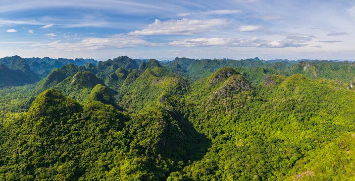 Aerial view of the lush green limestone karst mountains and dense tropical forest of Cat Ba Island in Cat Hai, Hai Phong, Vietnam.