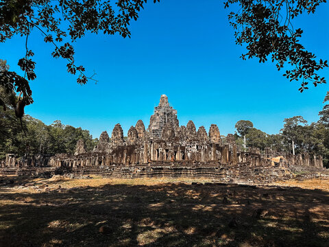 Krong Siem Reap, Siem Reap Province, Cambodia - 10 February 2026: View of the ancient Bayon Temple with its iconic stone towers and intricate carvings under a clear blue sky.