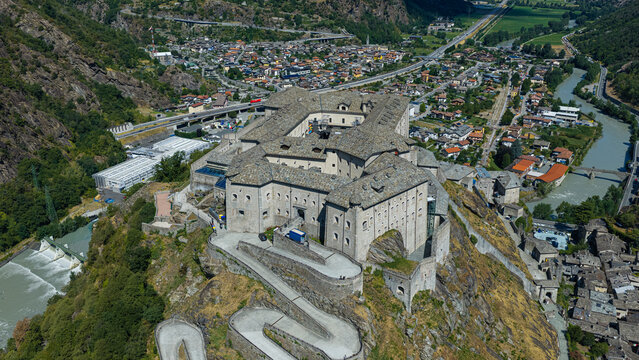 Aerial view of the historic Forte di Bard fortress perched on a rocky cliff overlooking the town and the Dora Baltea river in Bard, Valle d'Aosta, Italy.