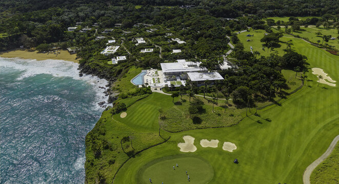 Aerial view of Amanera resort on a cliffside overlooking the ocean, with a golf course and lush tropical vegetation in Rio San Juan, Maria Trinidad Sanchez, Dominican Republic.