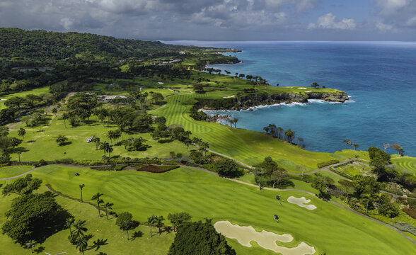 Aerial view of Amanera golf course with lush fairways and sand traps along the coast overlooking the turquoise Caribbean Sea in Rio San Juan, Maria Trinidad Sanchez, Dominican Republic.