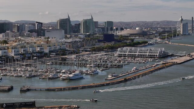 Aerial view of Parque das Nacoes marina with yachts and modern architecture along the Tagus river in Lisbon, Lisbon, Portugal.