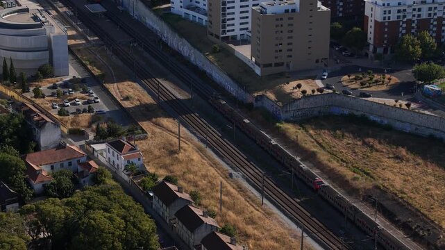 Aerial view of railway tracks passing through the urban landscape of Parque das Nacoes in Lisbon, Lisbon, Portugal.