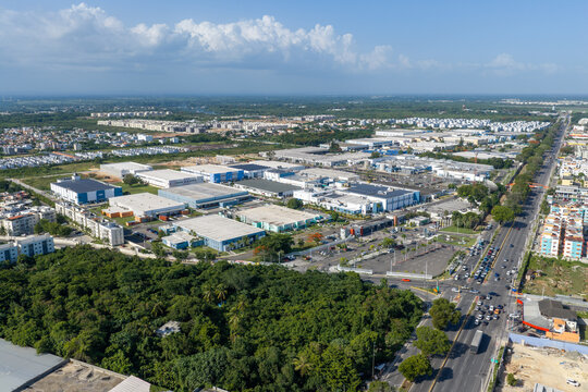 Aerial view of Zona Franca San Isidro industrial park with large warehouses, manufacturing facilities, and surrounding urban infrastructure in Santo Domingo East, Santo Domingo, Dominican Republic.