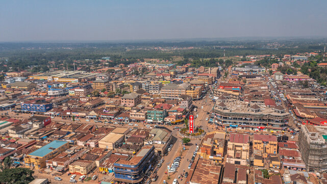Aerial view of the town of Mbale featuring a prominent central clock tower, busy streets, and a mix of commercial and residential buildings in Mbale, Eastern Region, Uganda.