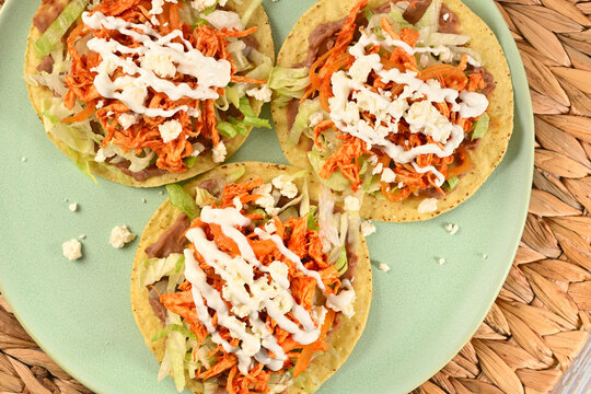 Delicious Mexican meal crispy tostadas with tinga lettuce and cotija cheese. Flat lay photography