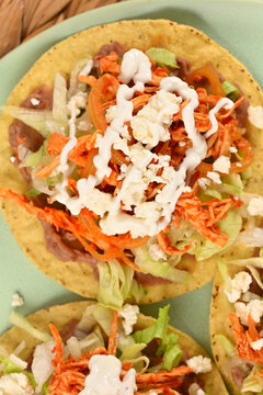 Top view of authentic Mexican street food crispy corn tostadas with shredded chicken