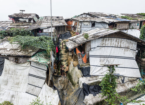 Cox's Bazar, Bangladesh - 17 July 2026: Aerial view of a dense refugee settlement with makeshift shelters made of bamboo and tarpaulins, narrow pathways, and residents.