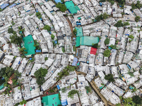 Cox's Bazar, Bangladesh - 17 July 2026: Aerial view of the dense settlement in Cox's Bazar, featuring rows of makeshift shelters with white tarpaulin roofs and narrow dirt pathways.