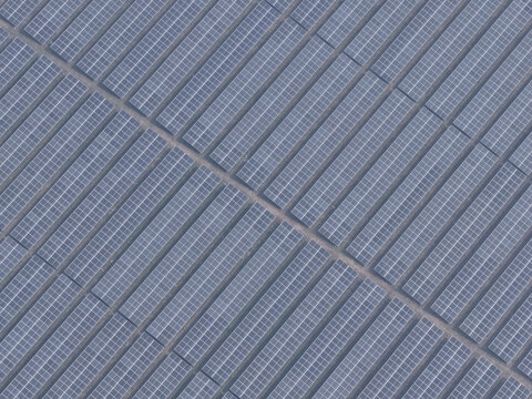Aerial view of a large solar farm with rows of photovoltaic panels arranged in a grid pattern in Gaibandha, Rangpur Division, Bangladesh.