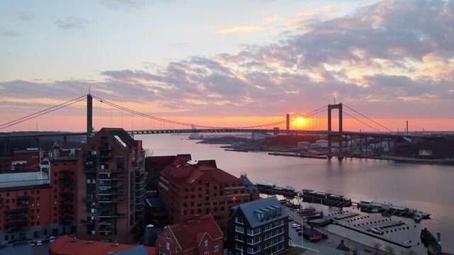 Aerial view of the Alvsborgsbron bridge over the Gota Alv river at sunset with the historic Klippan district buildings in the foreground in Goteborg, Vastra Gotalands lan, Sweden.