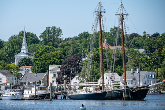 Mystic, Connecticut, USA - Historic Tall Ships and Church Along Waterfront