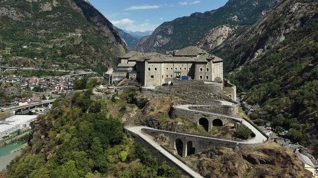 Aerial view of the historic Forte di Bard fortress perched on a rocky cliff overlooking the town and valley in Bard, Valle d'Aosta, Italy.