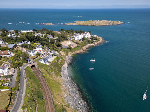 Aerial view of the Dalkey coastline featuring the railway tunnel, coastal houses, and Dalkey Island in the Irish Sea, Dublin, County Dublin, Ireland.