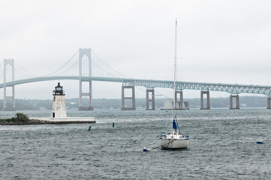 Goat Island Lighthouse, Newport, Rhode Island, with sailboat and Claiborne Bridge in background