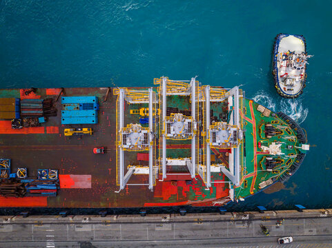 Aerial view of the Caucedo Logistics Center with a cargo ship docked alongside a tugboat in the port of Andres, Santo Domingo, Dominican Republic.