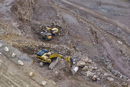 Frywald, Poland - 15 July 2026: Aerial view of Porphyry Mine Zalas with heavy machinery including excavators and dump trucks operating in the open pit quarry.