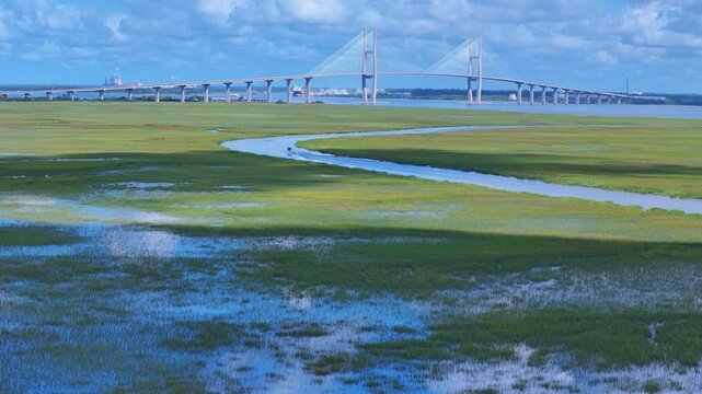 Aerial view of the Sidney Lanier Bridge spanning the marshlands and waterways near the coast of Jekyll Island, Georgia, United States.