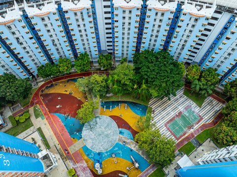 Aerial view of the Boon Keng residential complex featuring colorful playground surfaces, lush green trees, and modern high-rise housing blocks in Singapore, Bendemeer Road, Singapore.
