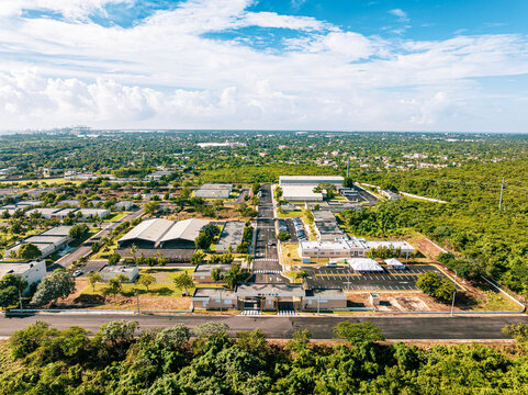 Aerial view of Base de Infanteria de Marina Valm. Manuel Ramon Montes Arache with military buildings, paved roads, and lush vegetation in Boca Chica, Santo Domingo, Dominican Republic.