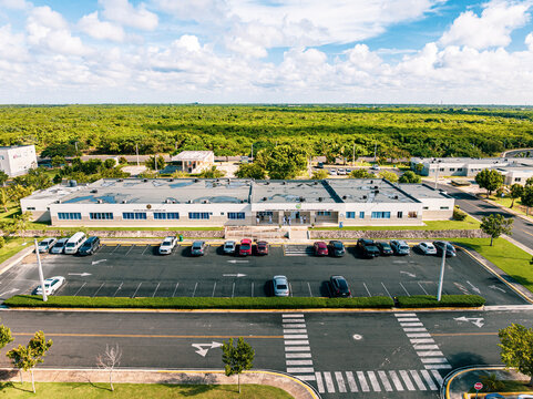 Aerial view of the Base de Infanteria de Marina Valm. Manuel Ramon Montes Arache, A.R.D. featuring a parking lot and modern facilities in Boca Chica, Santo Domingo, Dominican Republic.