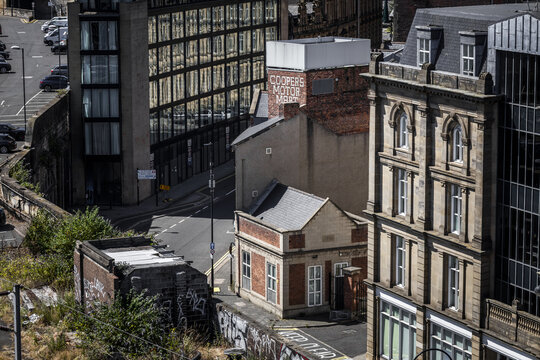 Aerial view of the historic Cooper's Motor Mart building nestled among modern and traditional architecture in Newcastle upon Tyne, England, United Kingdom.