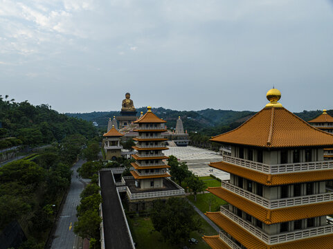 Aerial view of the Fo Guang Shan Buddha Museum featuring a golden Buddha statue, traditional pagodas with orange roofs, and courtyards in Jiuru Township, Pingtung County, Taiwan.