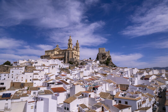 Aerial view of the historic town of Olvera with its iconic white houses, the Church of Nuestra Senora de la Encarnacion, and the Moorish castle in Olvera, Andalusia, Spain.