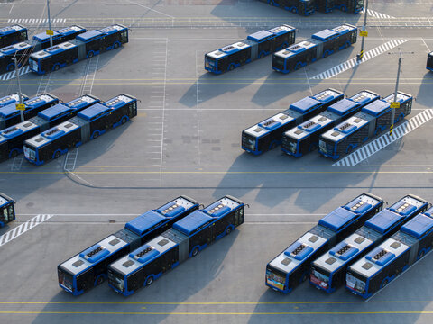 Krakow, Poland - 18 July 2026: Aerial view of a bus depot with rows of parked blue buses on asphalt.