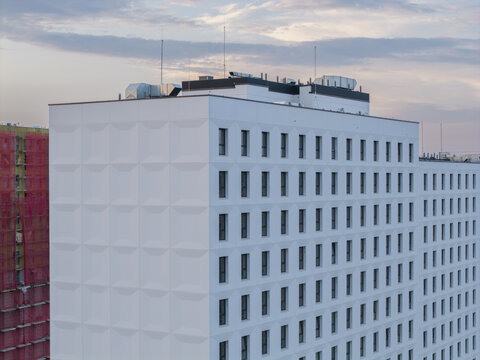 Aerial view of a modern white building with geometric facade textures under a soft evening sky in Krakow, Lesser Poland Voivode, Poland.