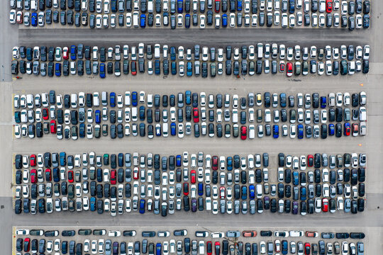 Ciemno-Gnojna, Poland - 11 July 2026: Aerial view of CAT Mosolf Polska Sp. z o.o. storage lot filled with rows of new cars parked in an orderly fashion.