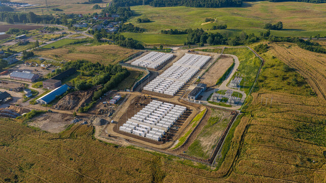 Nowa Wies Elcka, Poland - 17 July 2026: Aerial view of the BESS Elk battery energy storage system, featuring rows of white storage containers, electrical infrastructure, and surrounding fields.