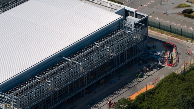 Aerial view of Data facility featuring industrial cooling units on the roof and surrounding infrastructure in Harlow, England, United Kingdom.