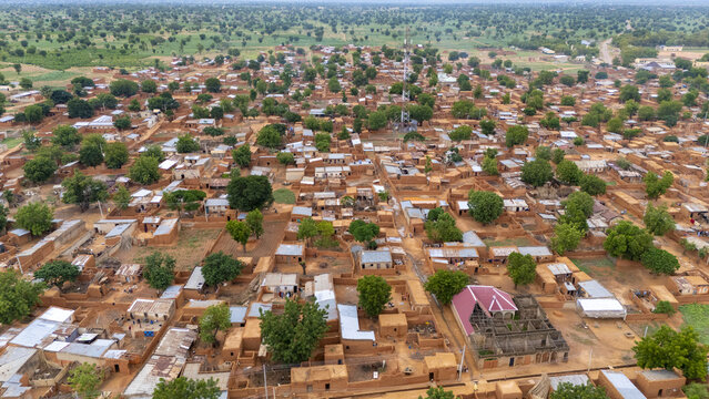 Aerial view of Dambatta, featuring traditional mud-brick houses, narrow streets, scattered trees, and a communication tower in Dambatta, Kano, Nigeria.
