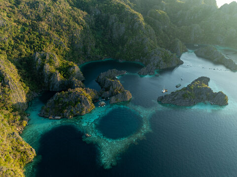 Aerial view of Twin Lagoon featuring turquoise waters, limestone cliffs, and lush vegetation in Coron, Mimaropa, Philippines.