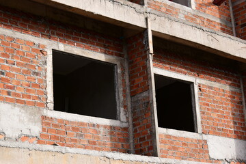 Fototapeta premium exterior view of brick house under construction with concrete structure