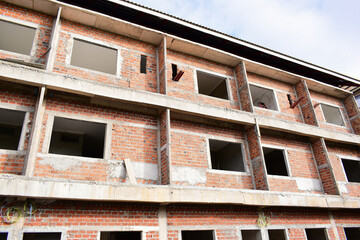 Fototapeta premium exterior view of brick house under construction with concrete structure
