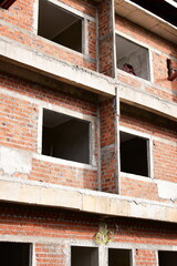Fototapeta premium exterior view of brick house under construction with concrete structure