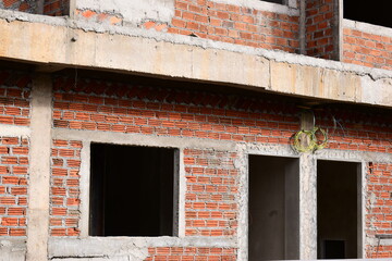 Fototapeta premium exterior view of brick house under construction with concrete structure