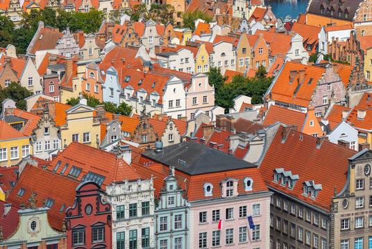 Aerial view of historic colorful buildings with orange tiled rooftops in the old town of Gdansk, Pomeranian Voivodeship, Poland.