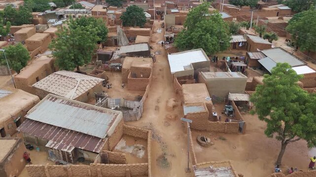 Aerial view of traditional mud brick houses and narrow dirt streets in the rural village of Danbatta, Kano, Nigeria.