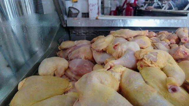 raw chicken pieces displayed in a butcher shop showcase