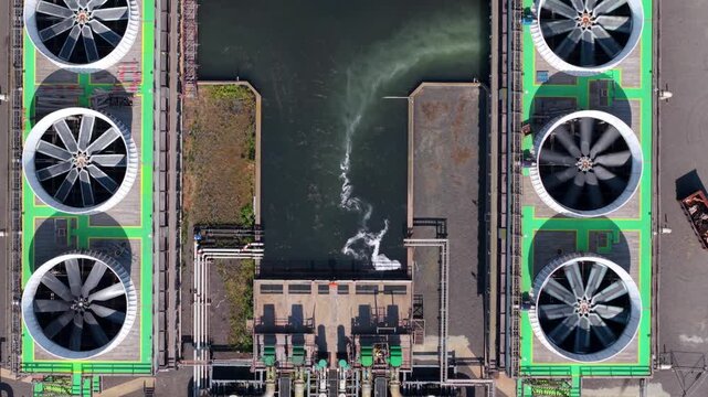 Aerial view of VPI Immingham power plant featuring large cooling fans and water intake structures in South Killingholme, England, United Kingdom.