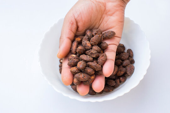hand showing healthy snack alternative that is high quality jaggery choco coated almonds