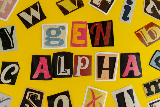 Gen Alpha text spelled with cutout letters on a yellow background. Generation Alpha demographic, modern youth culture concept.