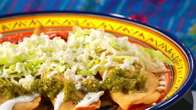 Authentic Mexican fried corn molotes topped with fresh shredded lettuce and spicy salsas