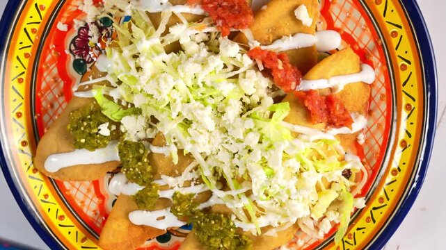 Mexican street food dish with crispy molotes, fresh ingredients and traditional spicy salsas