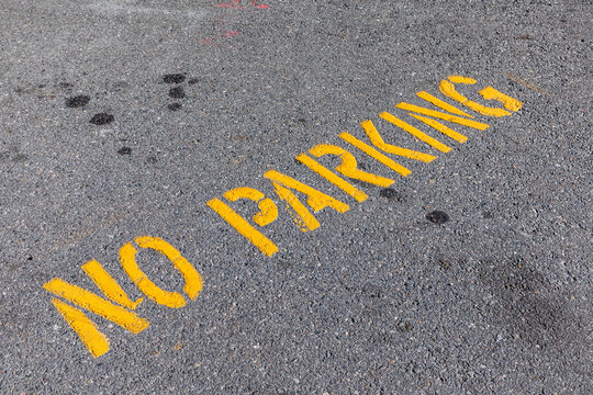 no parking signage in yellow painted at the street